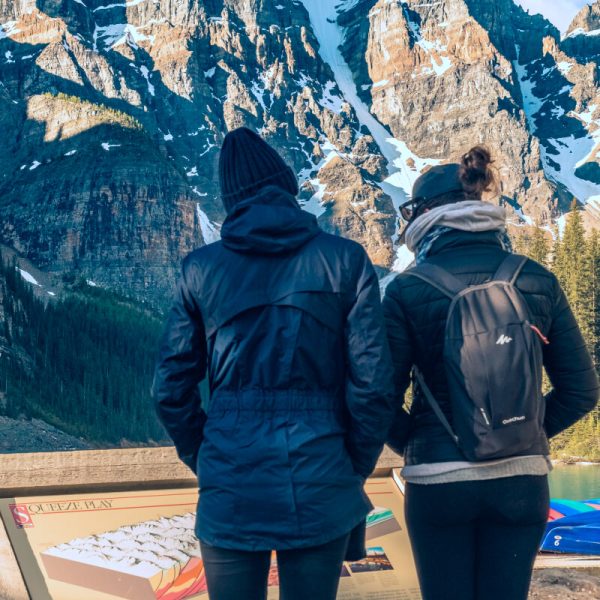 man-and-woman-standing-on-brown-wooden-dock-during-daytime