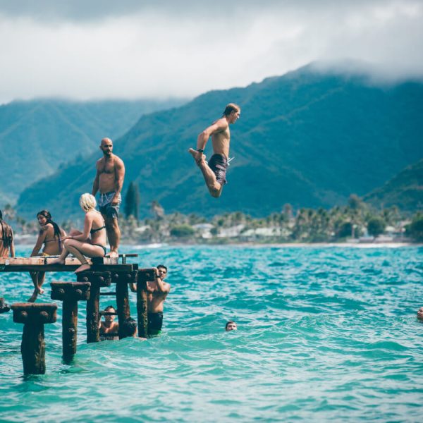 man-diving-from-dock-with-people
